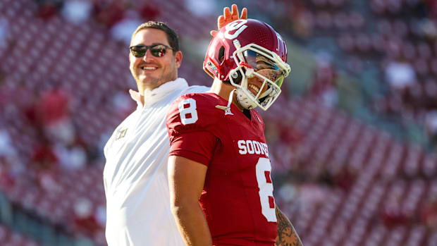 Oklahoma Sooners offensive coordinator Jeff Lebby laughs with Oklahoma Sooners quarterback Dillon Gabriel 