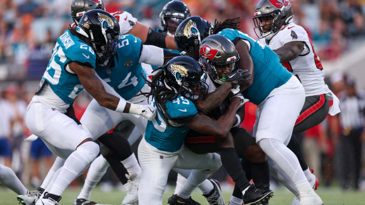 Aug 17, 2024; Jacksonville, Florida, USA; Tampa Bay Buccaneers running back Bucky Irving (7) is tackled by Jacksonville Jaguars safety Terrell Edmunds (45) in the first quarter before a preseason game at EverBank Stadium. Mandatory Credit: Nathan Ray Seebeck-USA TODAY Sports