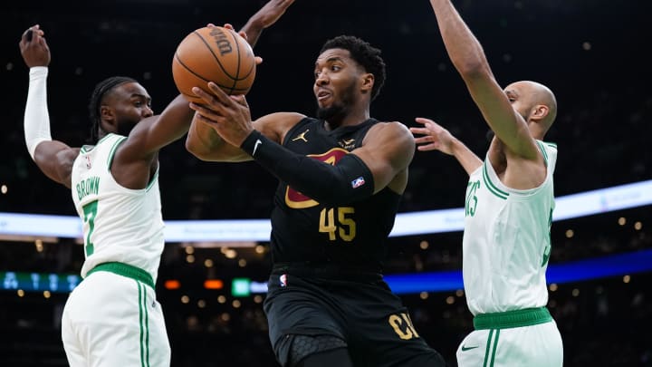 May 9, 2024; Boston, Massachusetts, USA; Cleveland Cavaliers guard Donovan Mitchell (45) passes the ball against Boston Celtics guard Jaylen Brown (7) and guard Derrick White (9) in the first quarter during game two of the second round for the 2024 NBA playoffs at TD Garden. Mandatory Credit: David Butler II-USA TODAY Sports
