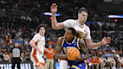 Mar 20, 2025; Providence, RI, USA; McNeese State Cowboys forward Christian Shumate (24) drives against Clemson Tigers center Viktor Lakhin (0) during the second half at Amica Mutual Pavilion. Mandatory Credit: Eric Canha-Imagn Images