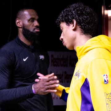 Apr 14, 2024; New Orleans, Louisiana, USA;  Los Angeles Lakers forward LeBron James (23) shakes hands with guard Max Christie (10) from the tunnel before the first half against the New Orleans Pelicans at Smoothie King Center. Mandatory Credit: Stephen Lew-USA TODAY Sports