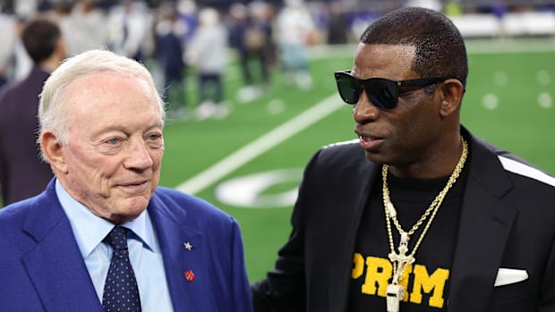 Colorado Buffaloes coach Deion Sanders (right) talks with Dallas Cowboys owner Jerry Jones before the game against the Seattl