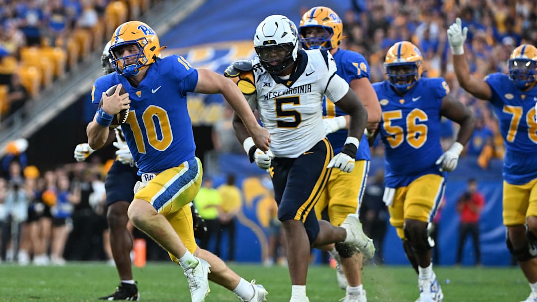 Sep 14, 2024; Pittsburgh, Pennsylvania, USA; Pittsburgh Panthers quarterback Eli Holstein (10) runs against West Virginia Mountaineers defensive lineman Sean Martin (5) during the fourth quarter at Acrisure Stadium. Mandatory Credit: Barry Reeger-Image Images