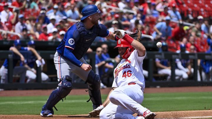 Jul 31, 2024; St. Louis, Missouri, USA;  St. Louis Cardinals first baseman Paul Goldschmidt (46) slides safely past Texas Rangers catcher Carson Kelly (18) to score during the second inning at Busch Stadium. Mandatory Credit: Jeff Curry-USA TODAY Sports