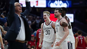 Nov 6, 2024; Storrs, Connecticut, USA; Connecticut Huskies forward Liam McNeeley (30), forward Alex Karaban (11) and Connecticut Huskies head coach Dan Hurley react after a play against the Sacred Heart Pioneers in the second half at Harry A. Gampel Pavilion. Mandatory Credit: David Butler II-Imagn Images