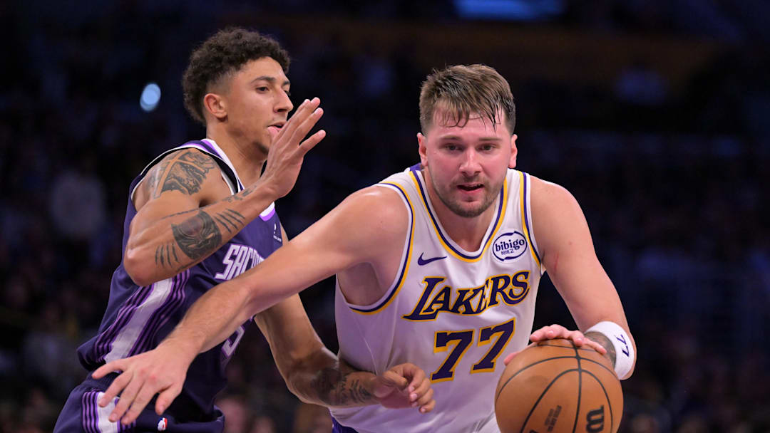 Dec 28, 2025; Los Angeles, California, USA;  Los Angeles Lakers guard Luka Doncic (77) is defended by Sacramento Kings guard Nique Clifford (5) in the second half at Crypto.com Arena. Mandatory Credit: Jayne Kamin-Oncea-Imagn Images