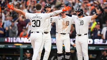 Detroit Tigers designated hitter Kerry Carpenter (30), left, celebrates with teammates center fielder Parker Meadows (22), shortstop Trey Sweeney (27) and first base Spencer Torkelson (20) after batting a grand slam against Chicago White Sox during the fifth inning at Comerica Park in Detroit on Sunday, Sept. 29, 2024.