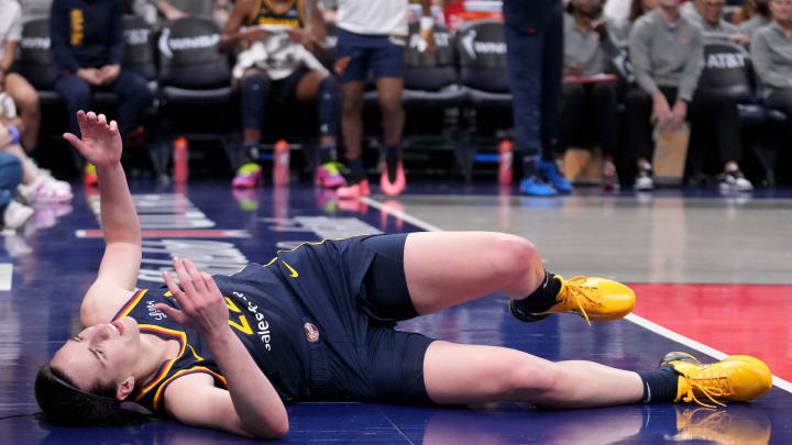 Indiana Fever guard Caitlin Clark (22) takes a moment after she falls during the second half of a game against the Seattle Storm on Sunday, Aug. 18, 2024, at Gainbridge Fieldhouse in Indianapolis. The Fever defeated the Storm 92-75.