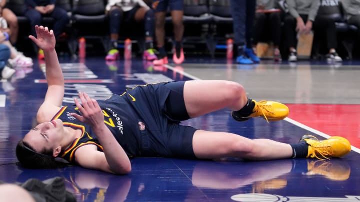 Indiana Fever guard Caitlin Clark (22) takes a moment after she falls during the second half of a game against the Seattle Storm on Sunday, Aug. 18, 2024, at Gainbridge Fieldhouse in Indianapolis. The Fever defeated the Storm 92-75.