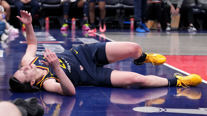 Indiana Fever guard Caitlin Clark (22) takes a moment after she falls during the second half of a game against the Seattle Storm on Sunday, Aug. 18, 2024, at Gainbridge Fieldhouse in Indianapolis. The Fever defeated the Storm 92-75.