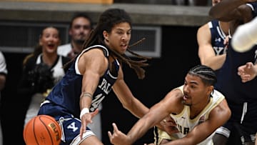 Nov 11, 2024; West Lafayette, Indiana, USA; Purdue Boilermakers guard C.J. Cox (0) passes the ball away from Yale Bulldogs forward Casey Simmons (14) during the first half at Mackey Arena. Mandatory Credit: Marc Lebryk-Imagn Images
