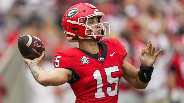Georgia Bulldogs quarterback Carson Beck attempts a pass during a college football game in the SEC.