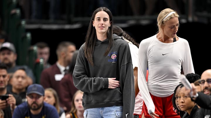 Indiana Fever guard Caitlin Clark looks on from the team bench during the game against the Dallas Wings.