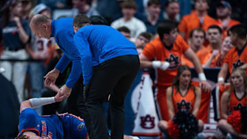 Florida Gators center Micah Handlogten (3) is cared for by medical personnel after going down against Auburn during the SEC Men's Basketball Tournament Championship game at Bridgestone Arena in Nashville, Tenn., Sunday, March 17, 2024 at Bridgestone Arena in Nashville, Tenn., Sunday, March 17, 2024.