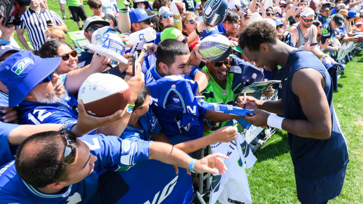 Jul 30, 2023; Renton, WA, USA; Seattle Seahawks quarterback Geno Smith (7) signs autographs after practice at the Virginia Mason Athletic Center. Mandatory Credit: Steven Bisig-USA TODAY Sports