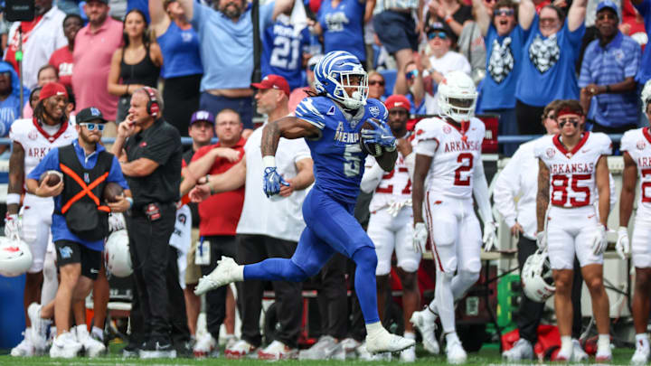 Sep 20, 2025; Memphis, Tennessee, USA; Memphis Tigers running back Sutton Smith (5) runs for a touchdown against the Arkansas Razorbacks during the second half at Simmons Bank Liberty Stadium. Mandatory Credit: Wesley Hale-Imagn Images