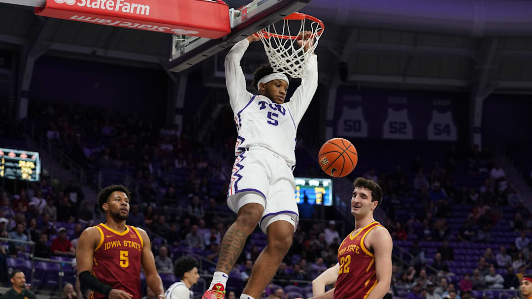 Feb 10, 2026; Fort Worth, Texas, USA;  TCU Horned Frogs forward Micah Robinson (5) follows through on a dunk as Iowa State Cyclones forward Joshua Jefferson (5) and forward Milan Momcilovic (22) look on during the first half at Ed and Rae Schollmaier Arena. Mandatory Credit: Raymond Carlin III-Imagn Images