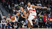 Oct 17, 2025; Toronto, Ontario, CAN; Brooklyn Nets guard Ben Saraf (77) dribbles the ball against Toronto Raptors forward/guard Scottie Barnes (4) during the first half at Scotiabank Arena. Mandatory Credit: Kevin Sousa-Imagn Images