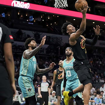 Mar 27, 2024; Charlotte, North Carolina, USA; Cleveland Cavaliers forward Isaac Okoro (35) with a reverse layup against the Charlotte Hornets during the first quarter at Spectrum Center. Mandatory Credit: Jim Dedmon-Imagn Images