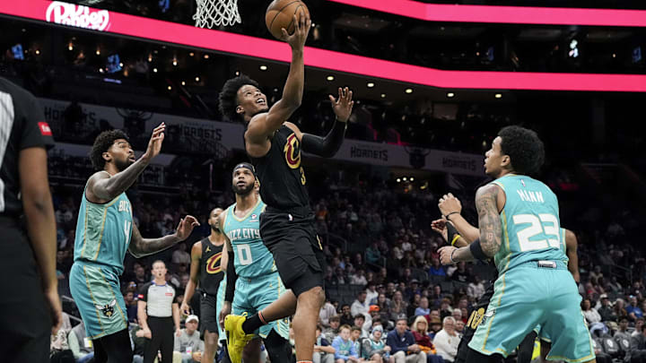 Mar 27, 2024; Charlotte, North Carolina, USA; Cleveland Cavaliers forward Isaac Okoro (35) with a reverse layup against the Charlotte Hornets during the first quarter at Spectrum Center. Mandatory Credit: Jim Dedmon-Imagn Images