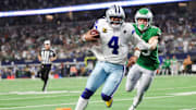 Nov 23, 2025; Arlington, Texas, USA; Dallas Cowboys quarterback Dak Prescott (4) runs with the ball in attempt to score a touchdown in the fourth quarter against the Philadelphia Eagles at AT&T Stadium. 