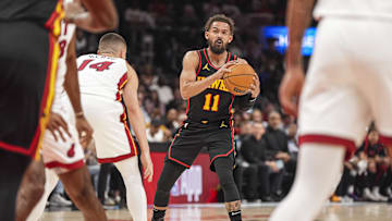 Apr 18, 2025; Atlanta, Georgia, USA; Atlanta Hawks guard Trae Young (11) controls the ball against Miami Heat guard Tyler Herro (14) during the first half at State Farm Arena. Mandatory Credit: Dale Zanine-Imagn Images
