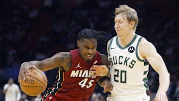 Nov 26, 2025; Miami, Florida, USA; Milwaukee Bucks guard AJ Green (20) defends against Miami Heat guard Davion Mitchell (45) during the second half of an NBA Cup game at Kaseya Center. Mandatory Credit: Rhona Wise-Imagn Images