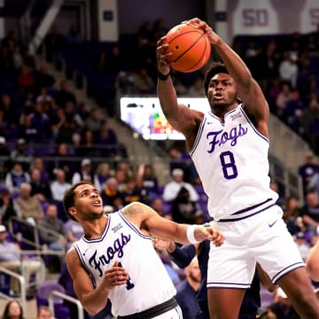 Feb 12, 2024; Fort Worth, Texas, USA;  TCU Horned Frogs center Ernest Udeh Jr. (8) grabs a rebound during the second half against the West Virginia Mountaineers at Ed and Rae Schollmaier Arena. Mandatory Credit: Kevin Jairaj-USA TODAY Sports