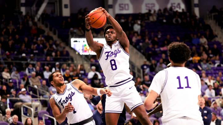 Feb 12, 2024; Fort Worth, Texas, USA;  TCU Horned Frogs center Ernest Udeh Jr. (8) grabs a rebound during the second half against the West Virginia Mountaineers at Ed and Rae Schollmaier Arena. Mandatory Credit: Kevin Jairaj-USA TODAY Sports