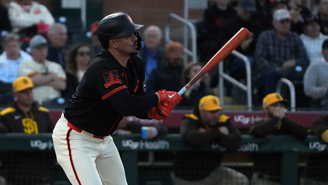 Mar 18, 2025; Scottsdale, Arizona, USA; San Francisco Giants shortstop Willy Adames (2) hits a single against the San Diego Padres in the second inning at Scottsdale Stadium. 