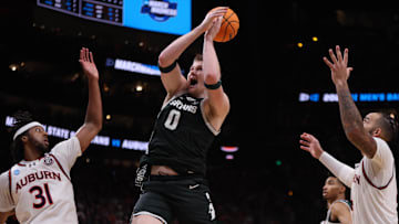 Mar 30, 2025; Atlanta, GA, USA; Michigan State Spartans forward Jaxon Kohler (0) rebounds against Auburn Tigers forward Chaney Johnson (31) and forward Johni Broome (4) during the second half in the South Regional final of the 2025 NCAA tournament at State Farm Arena. Mandatory Credit: Brett Davis-Imagn Images