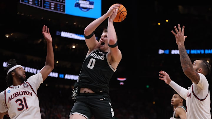 Mar 30, 2025; Atlanta, GA, USA; Michigan State Spartans forward Jaxon Kohler (0) rebounds against Auburn Tigers forward Chaney Johnson (31) and forward Johni Broome (4) during the second half in the South Regional final of the 2025 NCAA tournament at State Farm Arena. Mandatory Credit: Brett Davis-Imagn Images