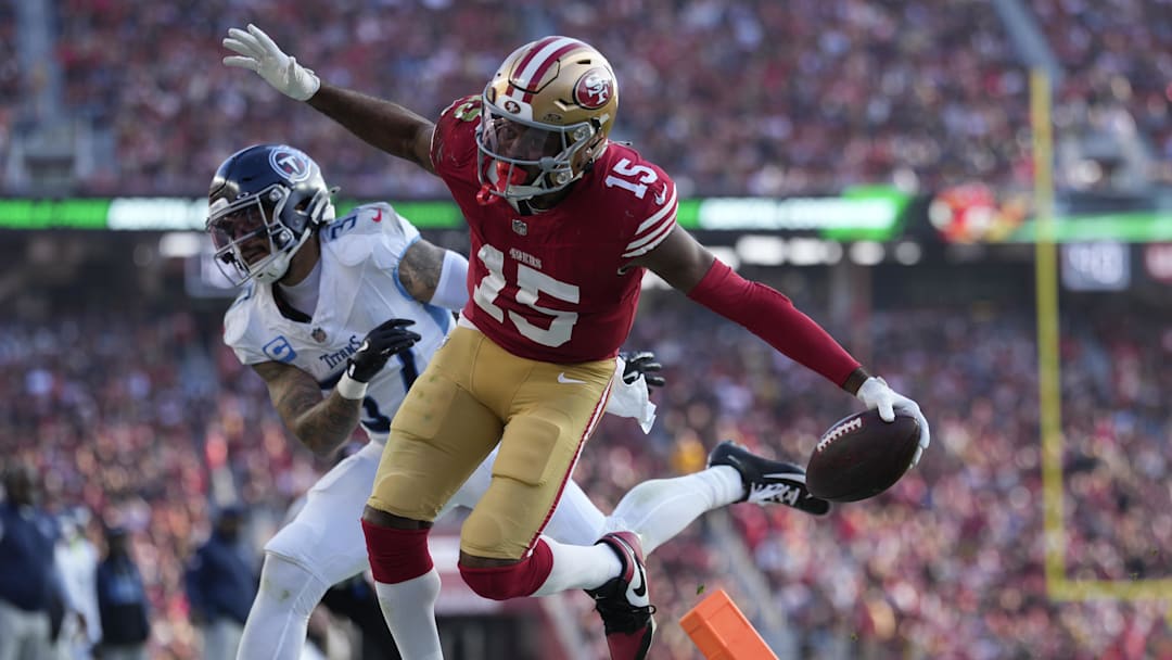Dec 14, 2025; Santa Clara, California, USA;  San Francisco 49ers wide receiver Jauan Jennings (15) scores a touchdown against Tennessee Titans safety Amani Hooker (37) during the third quarter at Levi's Stadium. Mandatory Credit: Kyle Terada-Imagn Images