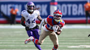 Sep 8, 2024; East Rutherford, New Jersey, USA; New York Giants wide receiver Wan'Dale Robinson (17) gains yards after catch in front of Minnesota Vikings safety Josh Metellus (44) during the second half at MetLife Stadium.  