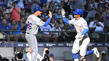 Sep 29, 2024; Milwaukee, Wisconsin, USA;New York Mets shortstop Francisco Lindor (12) is congratulated by New York Mets second base Eddy Alvarez (26) while rounding the bases after hitting a home run against the Milwaukee Brewers in the sixth inning at American Family Field. Mandatory Credit: Michael McLoone-Imagn Images