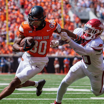 Sep 7, 2024; Stillwater, Oklahoma, USA; Oklahoma State Cowboys wide receiver Brennan Presley (80) breaks a tackle during the fourth quarter against the Arkansas Razorbacks at Boone Pickens Stadium. Mandatory Credit: William Purnell-Imagn Images