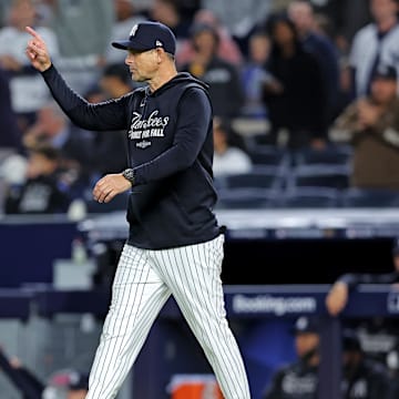 Oct 8, 2025; Bronx, New York, USA; New York Yankees manager Aaron Boone signals to the bullpen during the seventh inning against the Toronto Blue Jays during game four of the ALDS round for the 2025 MLB playoffs at Yankee Stadium. Mandatory Credit: Brad Penner-Imagn Images