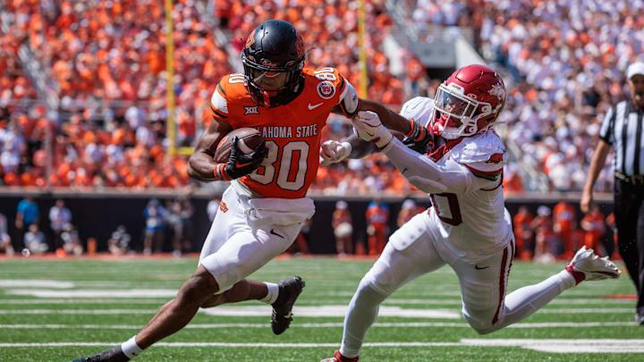 Sep 7, 2024; Stillwater, Oklahoma, USA; Oklahoma State Cowboys wide receiver Brennan Presley (80) breaks a tackle during the fourth quarter against the Arkansas Razorbacks at Boone Pickens Stadium. Mandatory Credit: William Purnell-Imagn Images