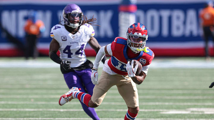 Sep 8, 2024; East Rutherford, New Jersey, USA; New York Giants wide receiver Wan'Dale Robinson (17) gains yards after catch in front of Minnesota Vikings safety Josh Metellus (44) during the second half at MetLife Stadium.  