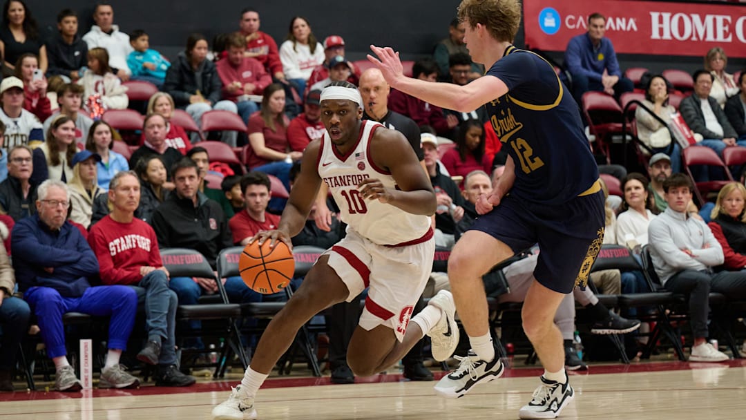 Dec 30, 2025; Stanford, California, USA; Stanford Cardinal forward Chisom Okpara (10) drives to the basket against Notre Dame Fighting Irish forward Garrett Sundra (12) during the second half at Maples Pavilion. Mandatory Credit: Robert Edwards-Imagn Images