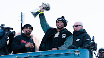 Philadelphia Eagles running back Saquon Barkley lifts the Lombardi Trophy during the Super Bowl LIX championship parade and rally. 
