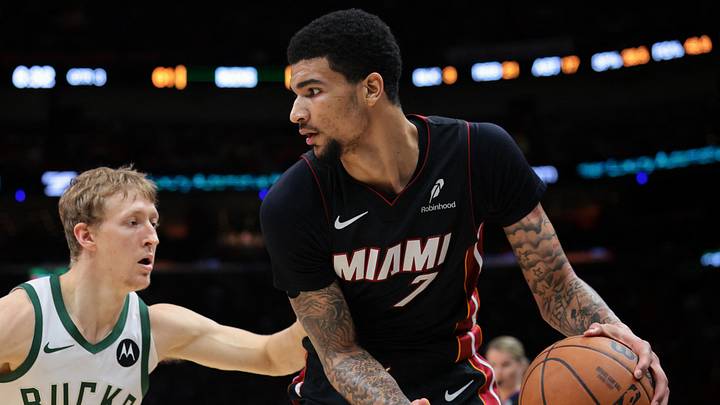 Mar 12, 2026; Miami, Florida, USA; Miami Heat center Kel'el Ware (7) protects the basketball against Milwaukee Bucks guard AJ Green (20) during the third quarter at Kaseya Center. Mandatory Credit: Sam Navarro-Imagn Images