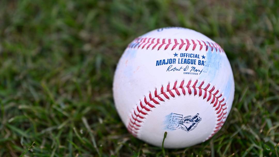 Jul 24, 2026; Boston, Massachusetts, USA; An official MLB baseball with a Toronto Blue Jays logo sits on the grass before a game against the Boston Red Sox at Fenway Park. Mandatory Credit: Eric Canha-Imagn Images