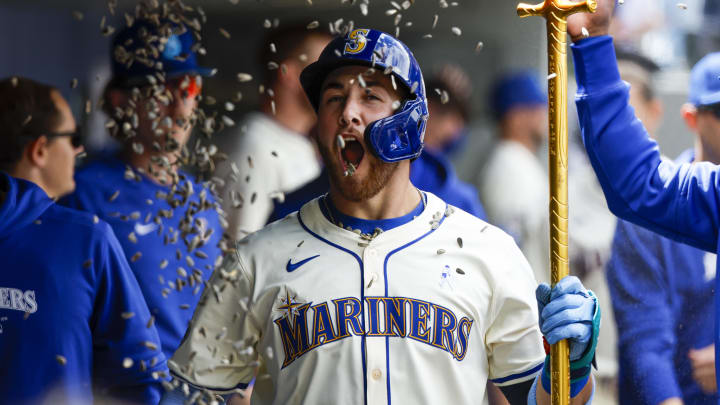 Seattle Mariners first baseman Tyler Locklear celebrates in the dugout with after hitting a solo home run against the Texas Rangers in June at T-Mobile Park.