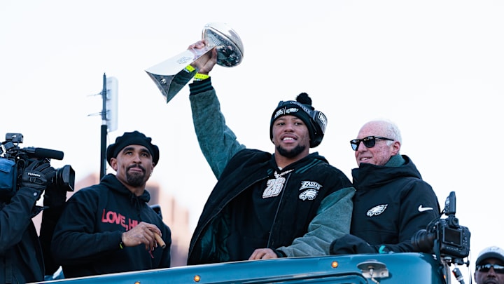 Feb 14, 2025; Philadelphia, PA, USA; Philadelphia Eagles running back Saquon Barkley (26) lifts the Lombardi Trophy during the Super Bowl LIX championship parade and rally. Mandatory Credit: Caean Couto-Imagn Images