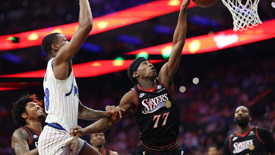 Philadelphia 76ers guard Vj Edgecombe reaches for a loose ball against Orlando Magic forward Jamal Cain.