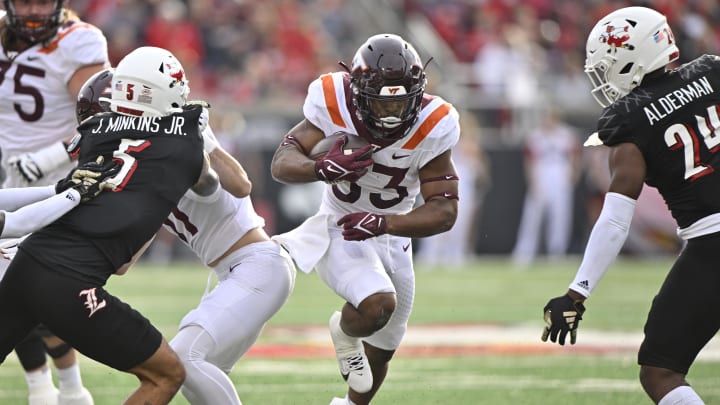 Nov 4, 2023; Louisville, Kentucky, USA;  Virginia Tech Hokies running back Bhayshul Tuten (33) runs the ball against Louisville Cardinals during the first half at L&N Federal Credit Union Stadium. Mandatory Credit: Jamie Rhodes-USA TODAY Sports