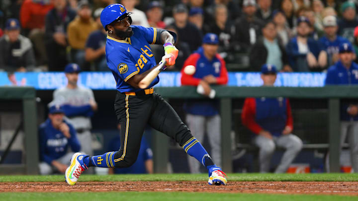 Seattle Mariners outfielder hits a walk-off single during a game against the Texas Rangers on Saturday at T-Mobile Park.