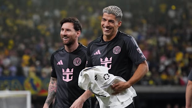 Lionel Messi and Luis Suarez modelling Inter Miami's new away kit.