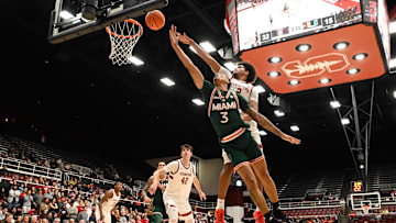 Jan 22, 2025; Stanford, California, USA; Miami (FL) Hurricanes guard Jalil Bethea (3) attempts a layup against Stanford Cardinal forward Donavin Young (2) in the first half at Maples Pavilion. Mandatory Credit: Eakin Howard-Imagn Images